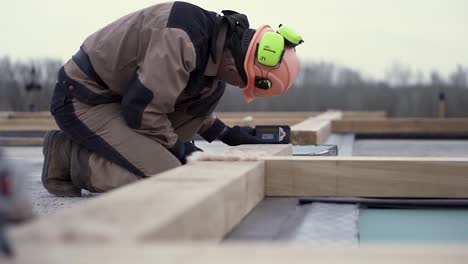 construction worker framing a house