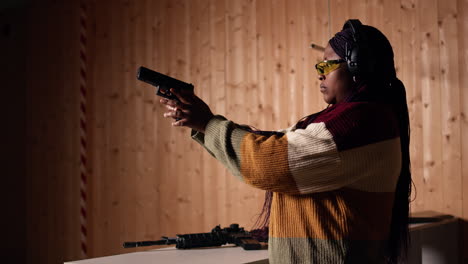 portrait of woman at shooting ground facility firing lethal fire weapon