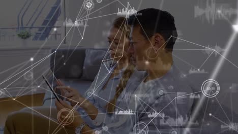 Animation-of-connections-over-diverse-woman-and-man-using-tablet