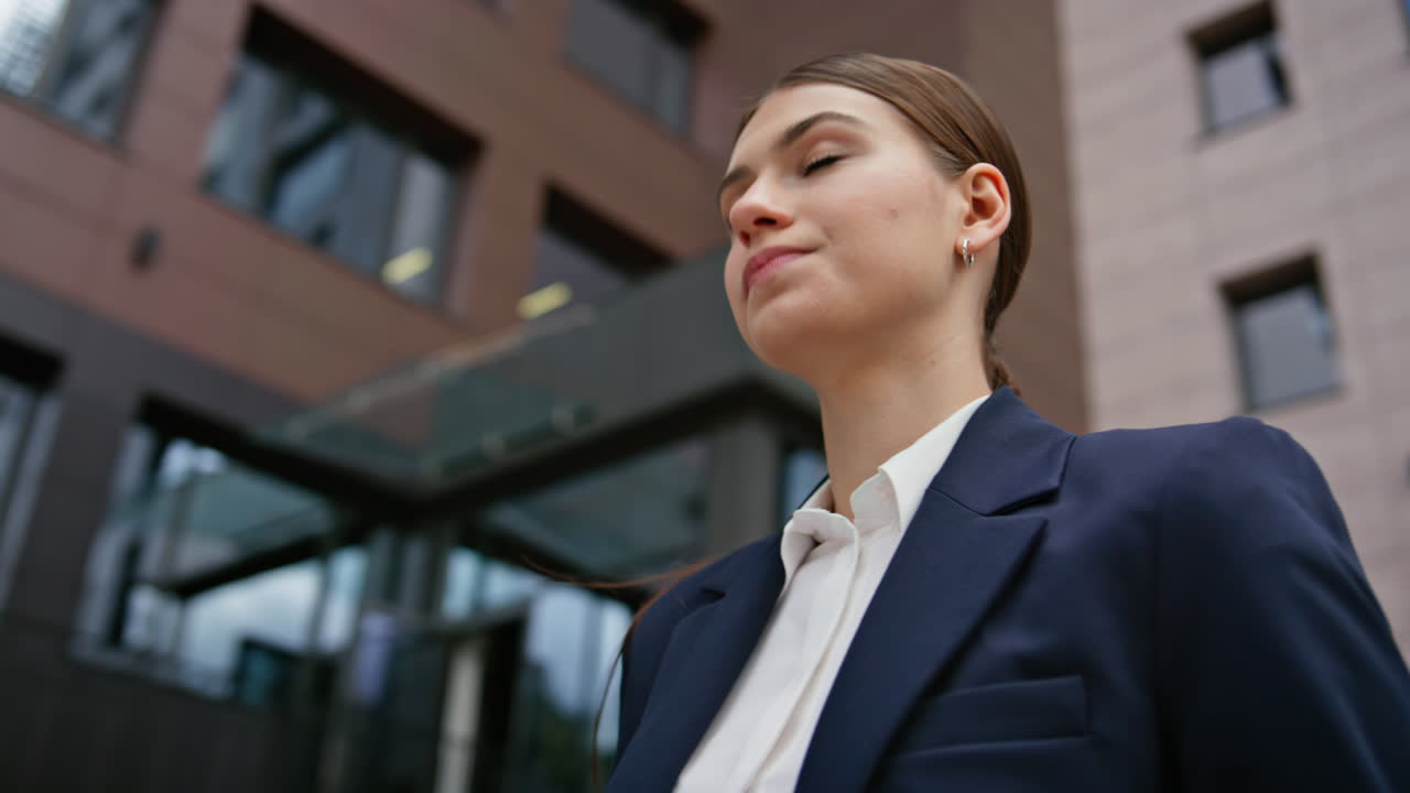 Confident woman reading documents standing outside office building closeup