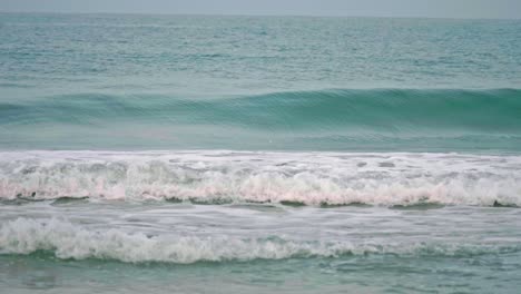 Ocean-waves-breaking-into-the-shore-on-the-beach-in-Phuket,-Thailand