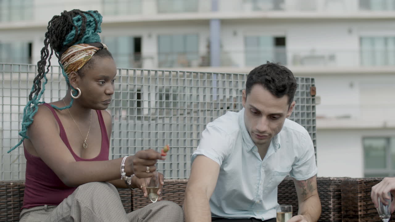 파티에서 카나페를 먹는 남녀 동료의 중간 샷