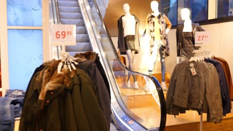 fashion store with escalator and clothing display