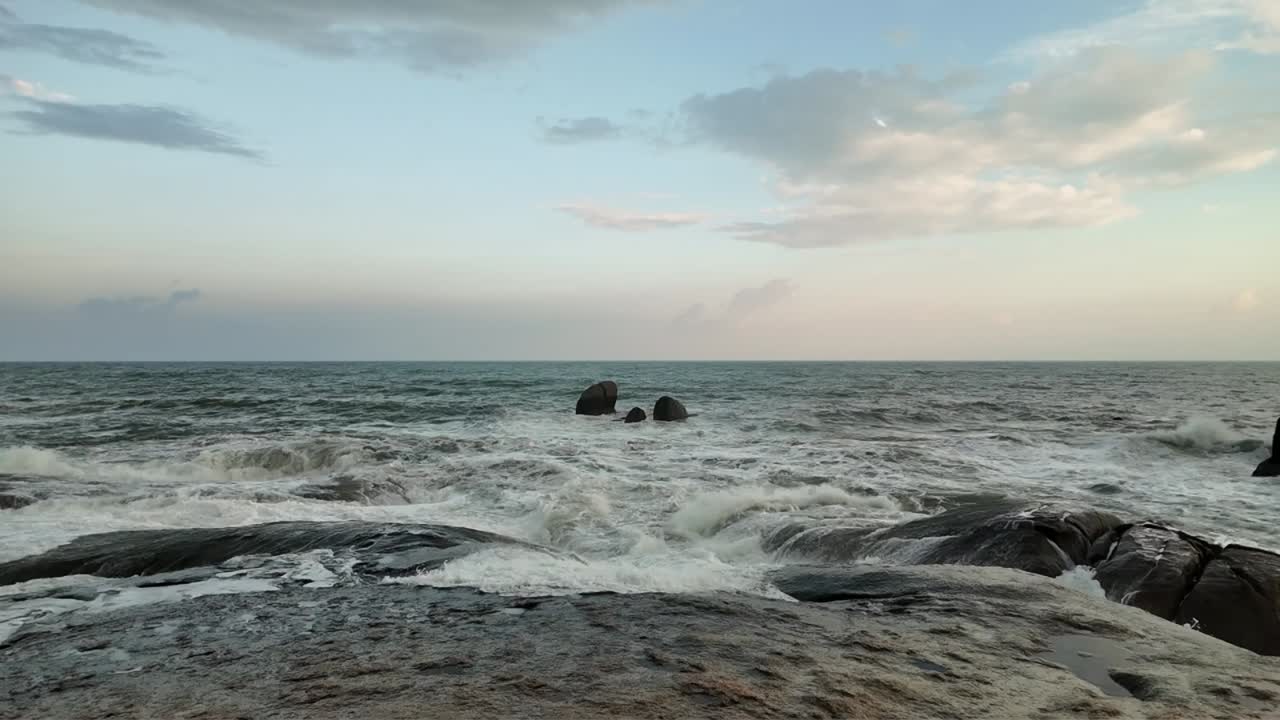 Slow-motion footage capturing the majestic sea waves crashing against the rocky and rugged coastline of Koh Samui, Thailand. Untouched beauty of nature, the essence of freedom, travel, and leisure