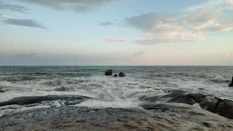 slow-motion footage capturing the majestic sea waves crashing against the rocky and rugged coastline of koh samui, thailand. untouched beauty of nature, the essence of freedom, travel, and leisure