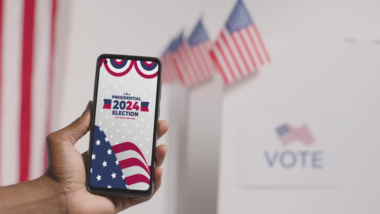 Close Up Of Hand Holding Mobile Phone With Screen Encouraging People To Vote In 2024 US Presidential Election