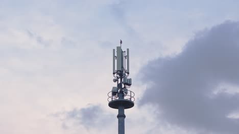 telecommunications tower with sky and clouds in the background