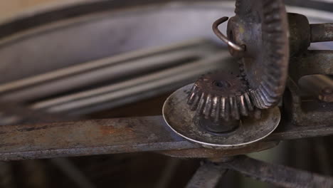 close up of rotating parts of honey extractor machine spinning, honeycomb hive frames turning around to extract fresh bee honey in traditional beekeeping-production farm