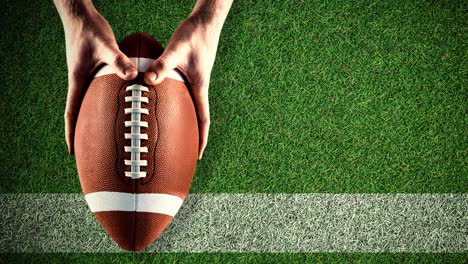 animation of american football ball on grass pitch background