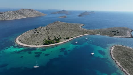 aerial view of boats sailing in the blue sea around the island in kornati, croatia.