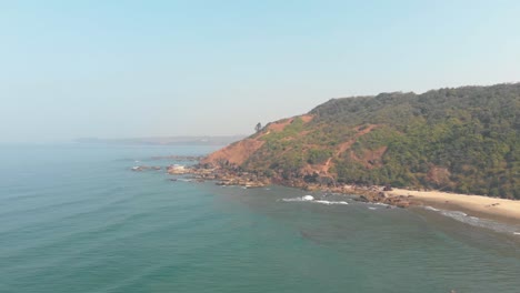 Panoramic-view-of-Arambol-beach-coastline-edge-tropical-landscape---Aerial-Panoramic-shot