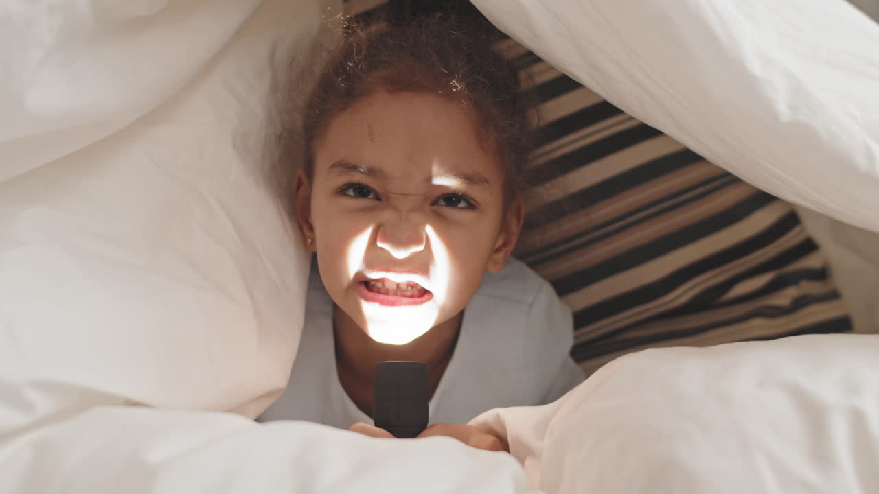 Girl Highlighting Face with Flashlight