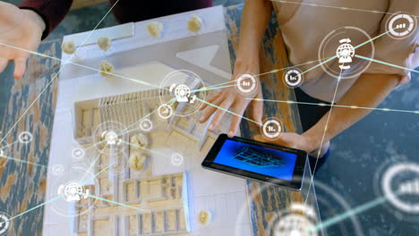 designing and planning architecture, people using tablet and building model over icons animation