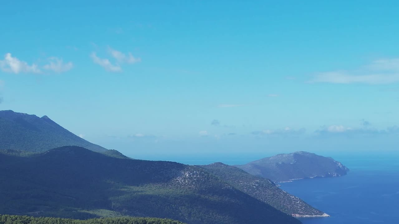 Aerial view of hills and sea landscape in Greece under clear blue sky