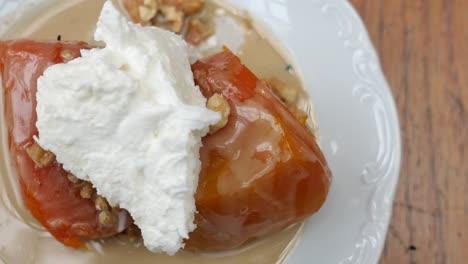 turkish pumpkin dessert with whipped cream and walnuts