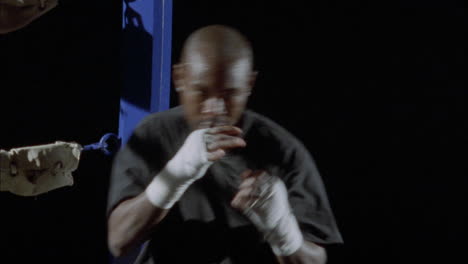 a boxer practices his punching outside of a ring