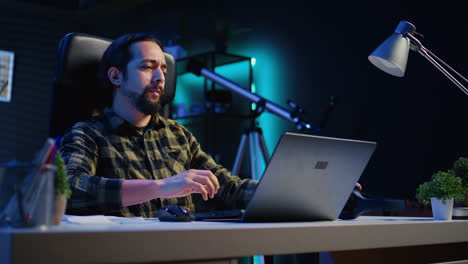 freelancer enjoying music while researching data for project at home