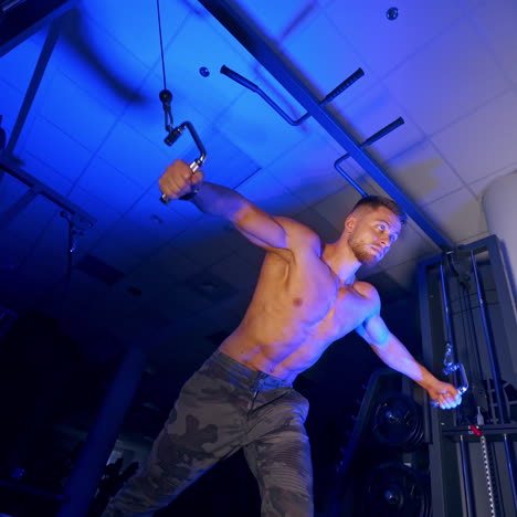 athlete with strong body doing work out pushing up excercise in gym. view from the bottom.