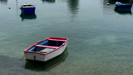 this video shows a small boat floating on a serene lake in a quaint village