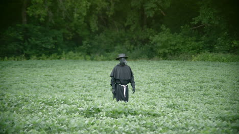 Plague-doctor-in-field-with-slow-motion-zoom-in