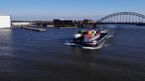 freight cargo barge with shipping containers cruising at noord river in netherlands