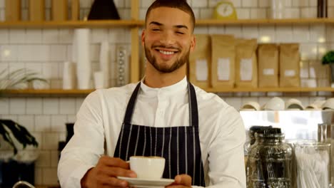 smiling waiter serving cup of coffee 4k