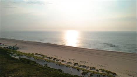 aerial view approaching sunset on monster beach, netherlands