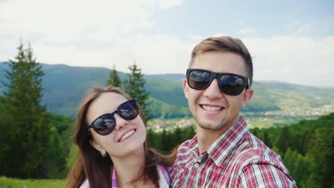 happy couple doing selfie on a background of beautiful mountains magnificent vacation and vacation