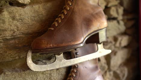 slowmo - old brown leather antique ice skating shoe on historic wall