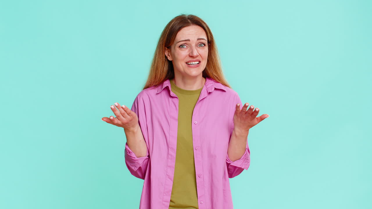 Adult woman smiling shaking head expressing disbelief sarcasm or amused reaction to silly situation