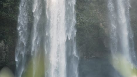 Waterfall-Plunging-From-High-Rocky-Cliff-Down-Into-The-River-In-Mayan-Forest,-Mexico