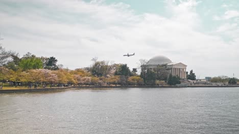 an airplane flying past the jefferson memorial