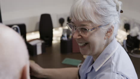 nurse assisting patient at desk