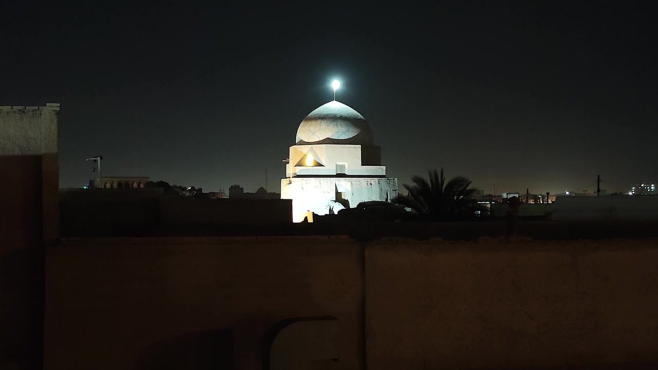 Illuminated Mosque Dome at Night in a Quiet City
