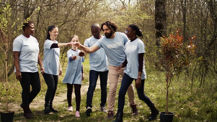 Cheerful proud team of activists join forces to clean a forest