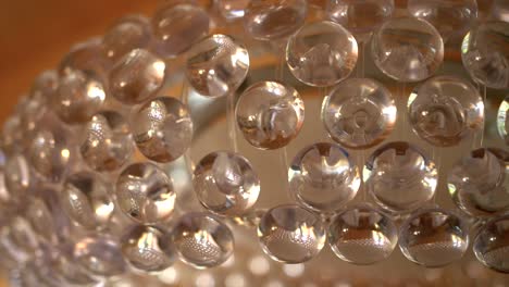 closeup dolly shot of modern elegant pendant light with a lot of glass droplets