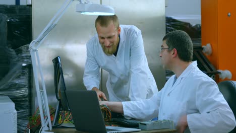 robotic engineers discussing over circuit board 4k