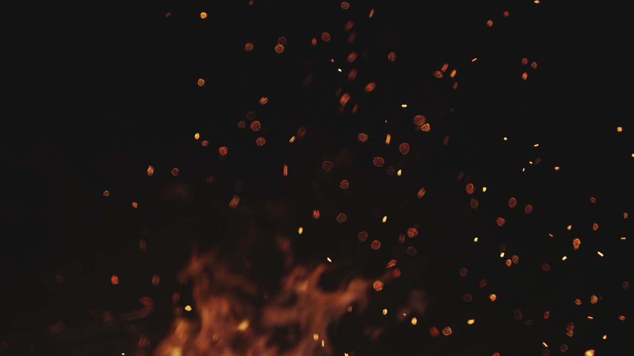 Burning flames and sparks in the dark