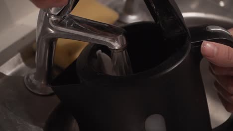 close up of a kettle being filled with water