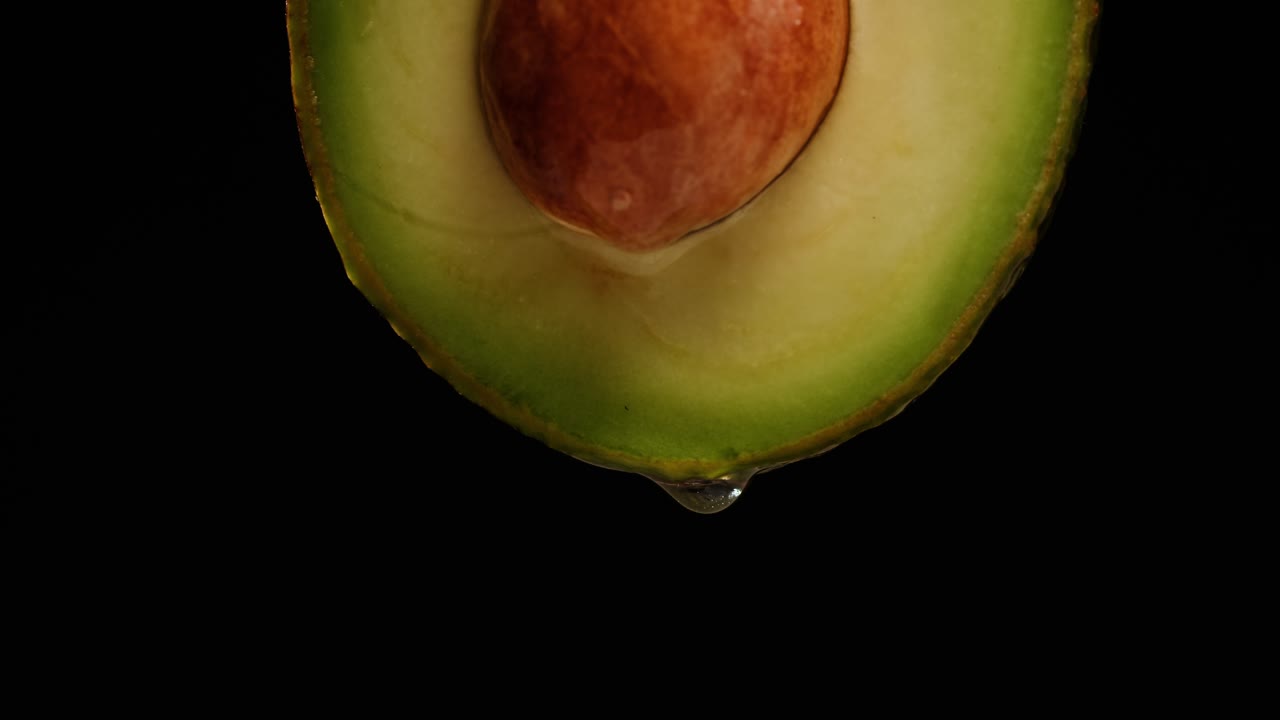 Close-up of an avocado slice with a water drop