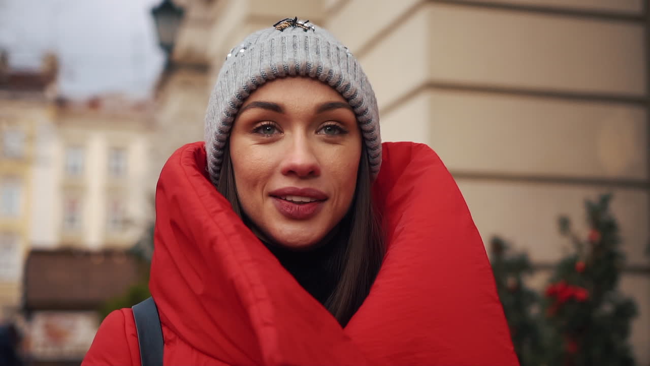 Woman in red coat and beanie