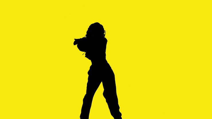 Studio Silhouette Of Woman Dancing Against Yellow Background