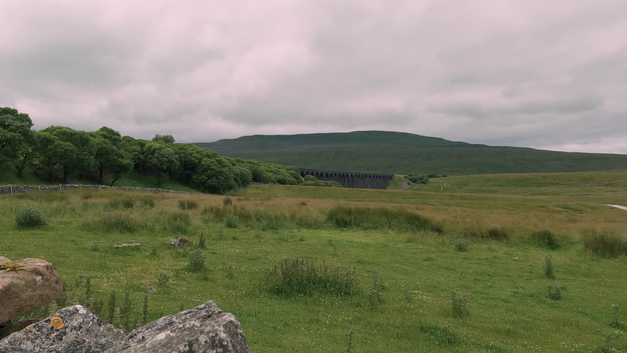North Yorkshire Whernside viaduct and green landscape fields, England countryside