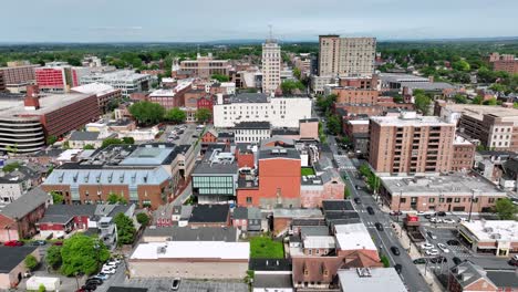 american city downtown of lancaster in pennsylvania at sunny spring day. aerial lateral wide shot. high-rise office buildings and traffic on roads at daytime.