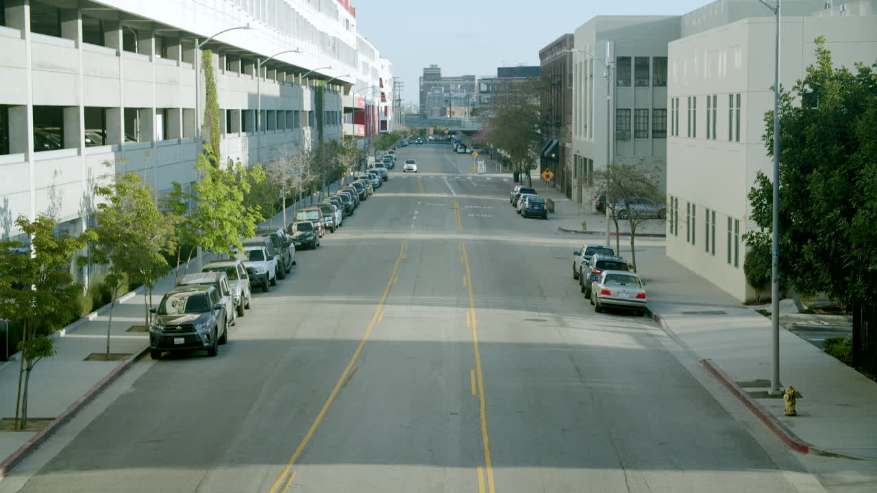 Empty city street with parked cars