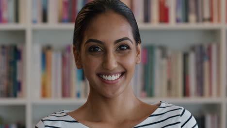 Indian-student-researcher-smiling-portrait-in-library-education-setting