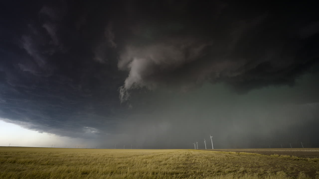 Supercell Storm Over Plains with Wind Turbines