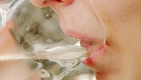 macro close up, female lips taking a sip of clear water from a transparent glass