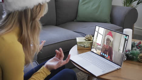 happy diverse male and female friends having christmas laptop video call, slow motion