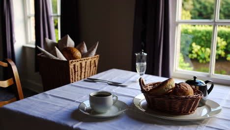 a cozy breakfast table with coffee and fresh bread